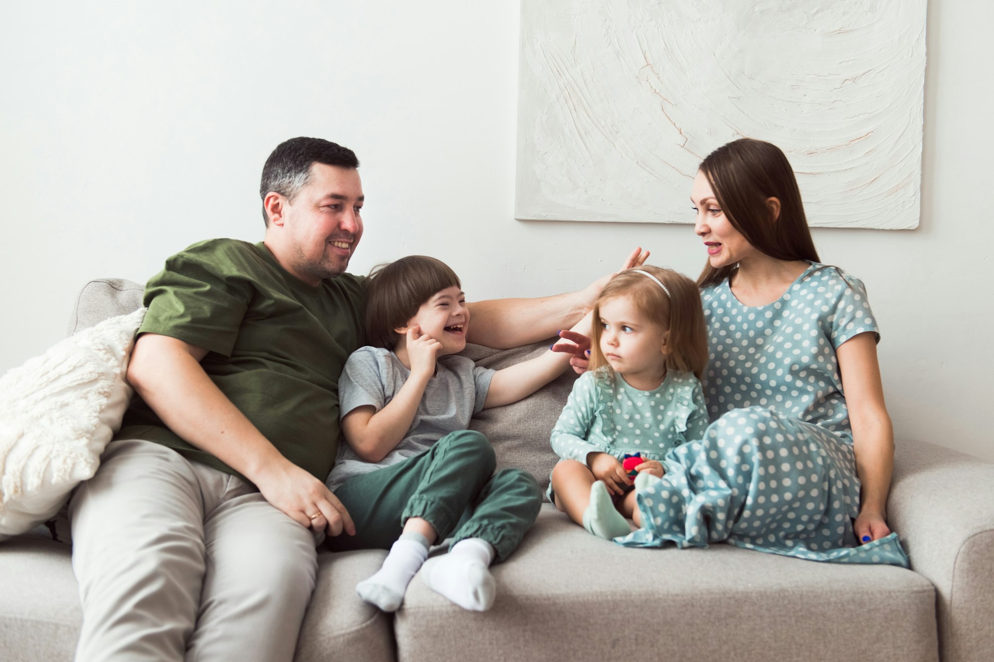 happy family sitting together on coach